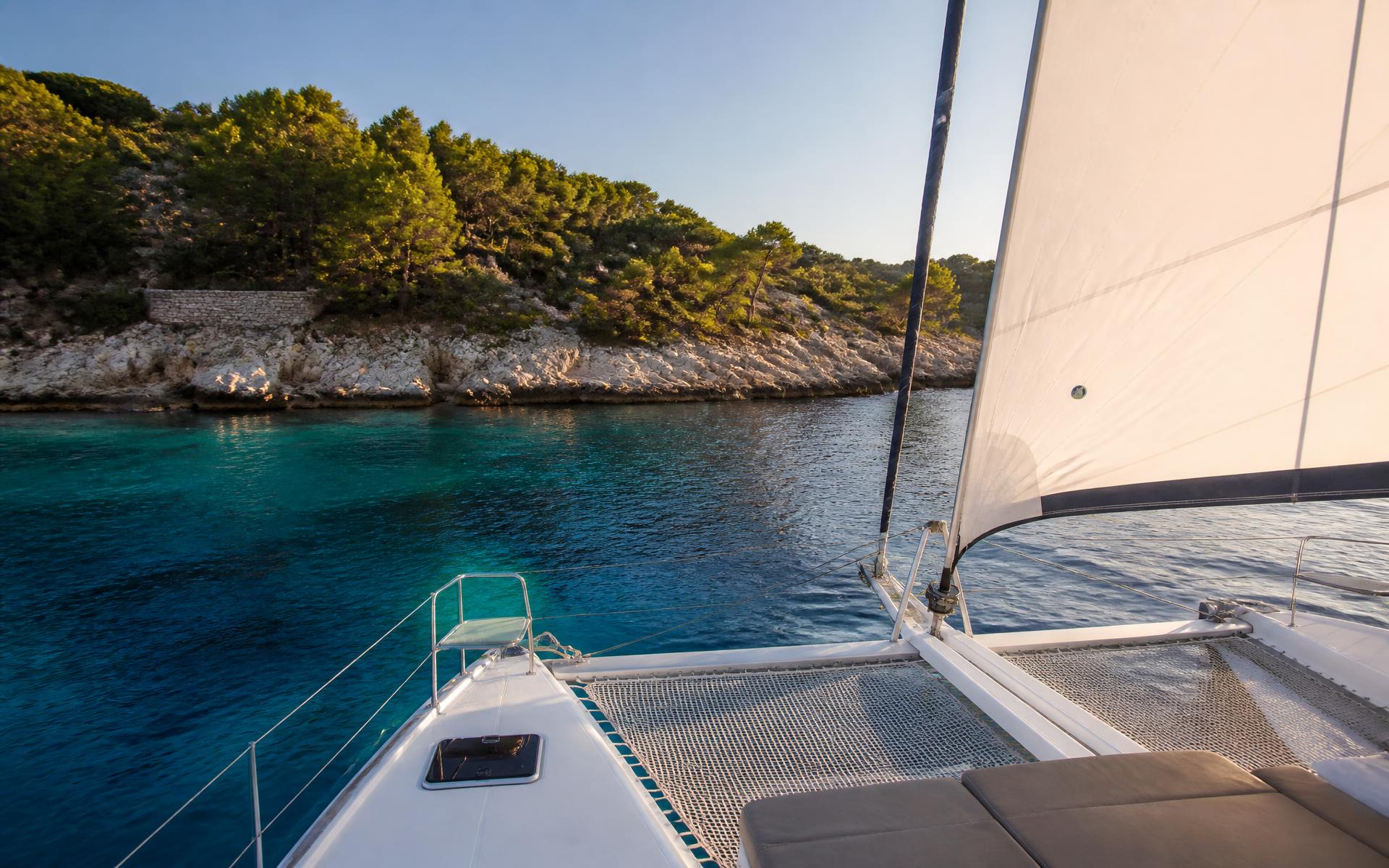 Sailing catamaran anchored in a turquoise Croatian cove